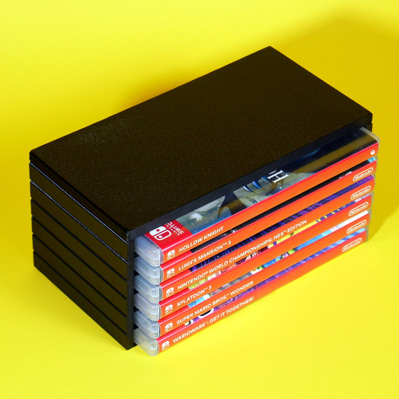 Nintendo Switch game cases stored in a modular stackable organizing tower angled view