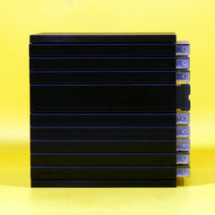 A stack of eight black rectangular electronic modules or battery packs with clear plastic end caps, set against a solid yellow background.