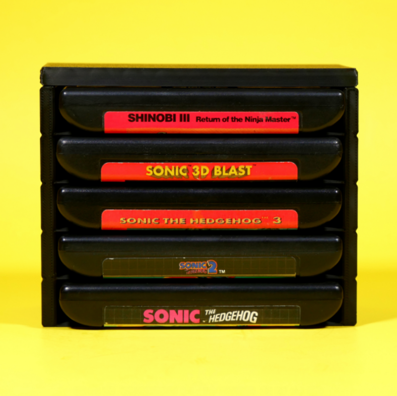Stack of Sega Genesis or Mega Drive game cartridges in a stackable modular organizer front view