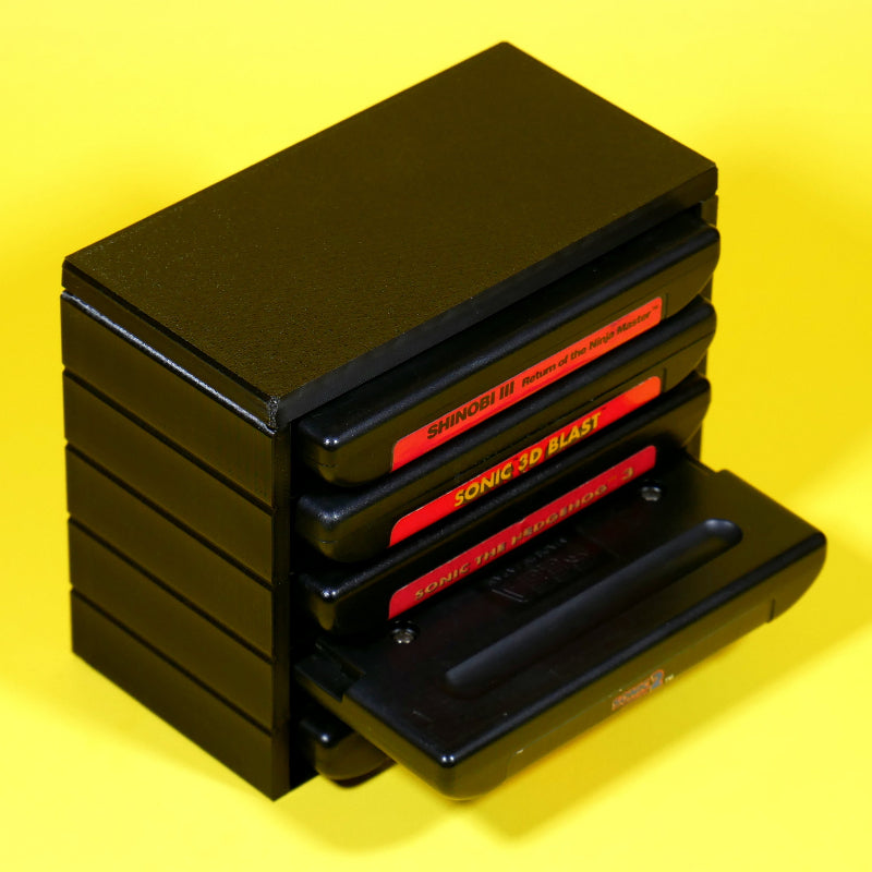 Stack of Sega Genesis or Mega Drive game cartridges in a stackable modular organizer with 1 cart pulled out